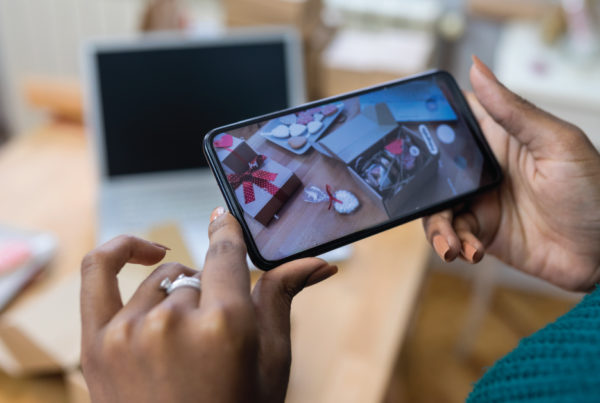 Photo of. person's hand taking a picture of Valentine's Day products, as suggested in Valentine's Day marketing tips